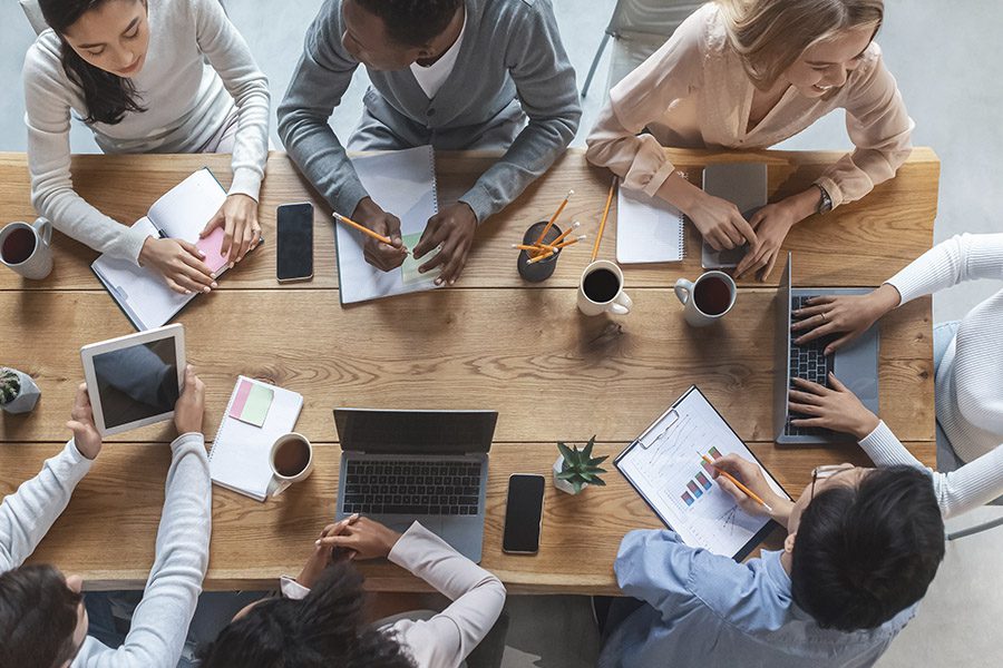 About Our Agency - Business Team Working Together At A Big Table